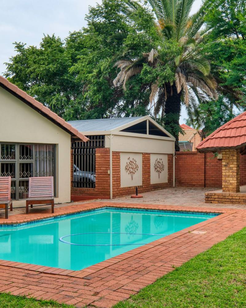 A face-brick house with a pool and a lapa in a Gauteng suburb